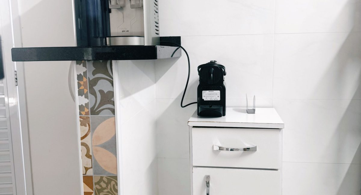 Detalhe de comodidades na casa em Juquehy com cofre eletrônico para segurança e purificador de água Consul na área de serviço.